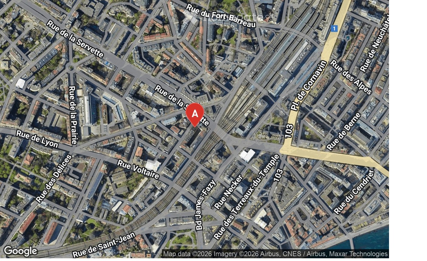 Aerial view of a city with multiple streets and buildings, marked with a red 'A'.