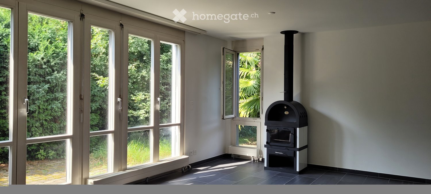 large windows, fireplace, black tiled floor