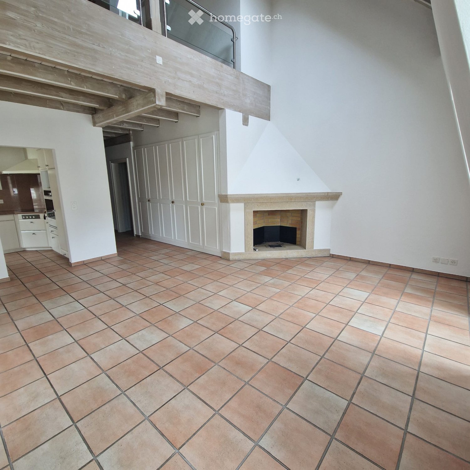 modern design, fireplace, tile flooring, white walls, white kitchen cabinets, wooden balcony