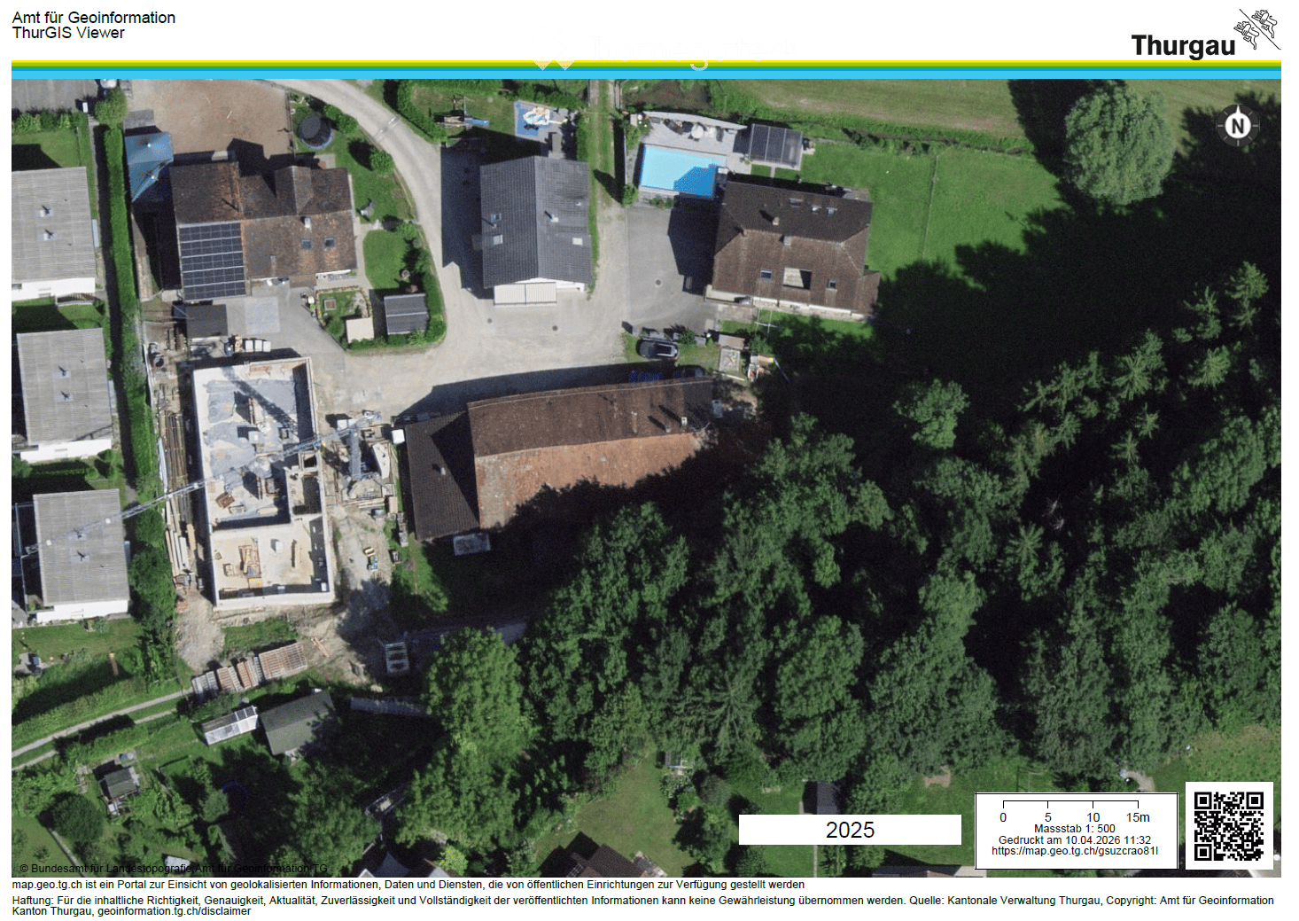 Aerial view of a residential area with several houses, a swimming pool, and a car parked in the driveway.