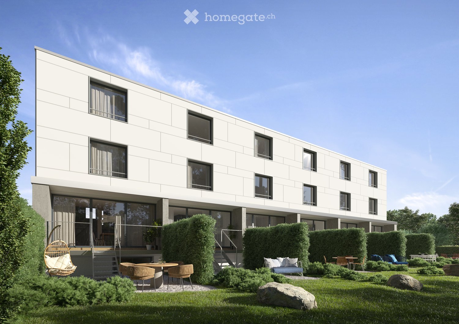 Modern two-story building with white facade and large windows, surrounded by a well-maintained garden with seating areas, a swing, and greenery.