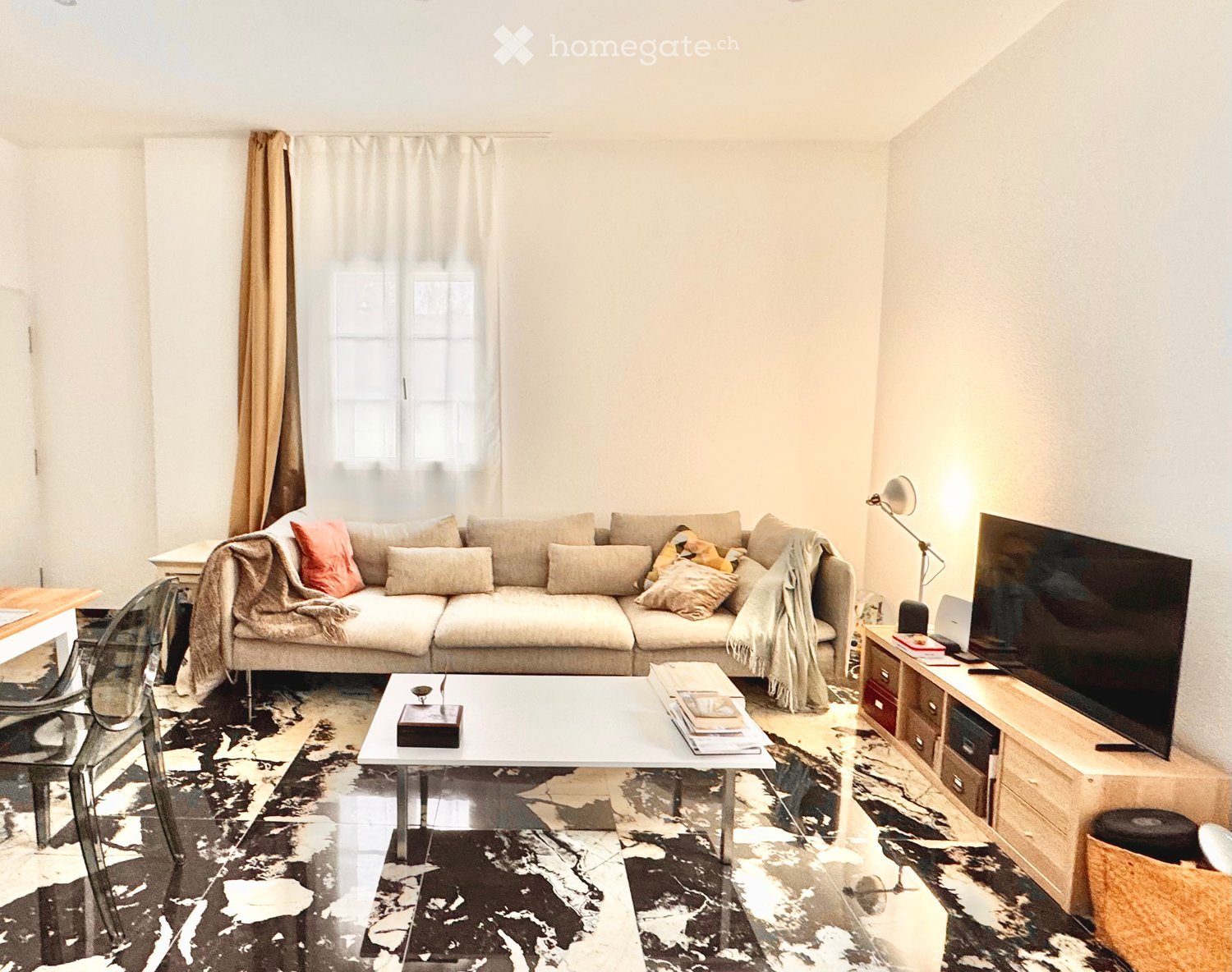 Modern living room with a large sofa, coffee table, TV stand, and a sleek, contemporary design.