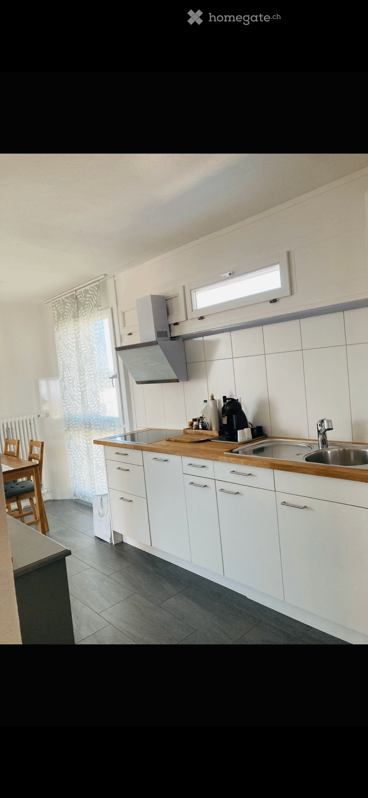 modern kitchen with white cabinets, wooden countertops, stainless steel sink, gas stove, extractor hood, white tiled walls, white ceiling