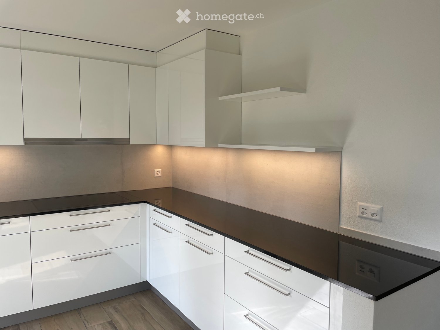 kitchen with modern cabinetry, dark countertop, electrical outlets, and drawers with pull-out handles