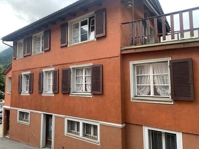 3 story house, brown exterior, white windows, balcony, multiple windows, brown shutters