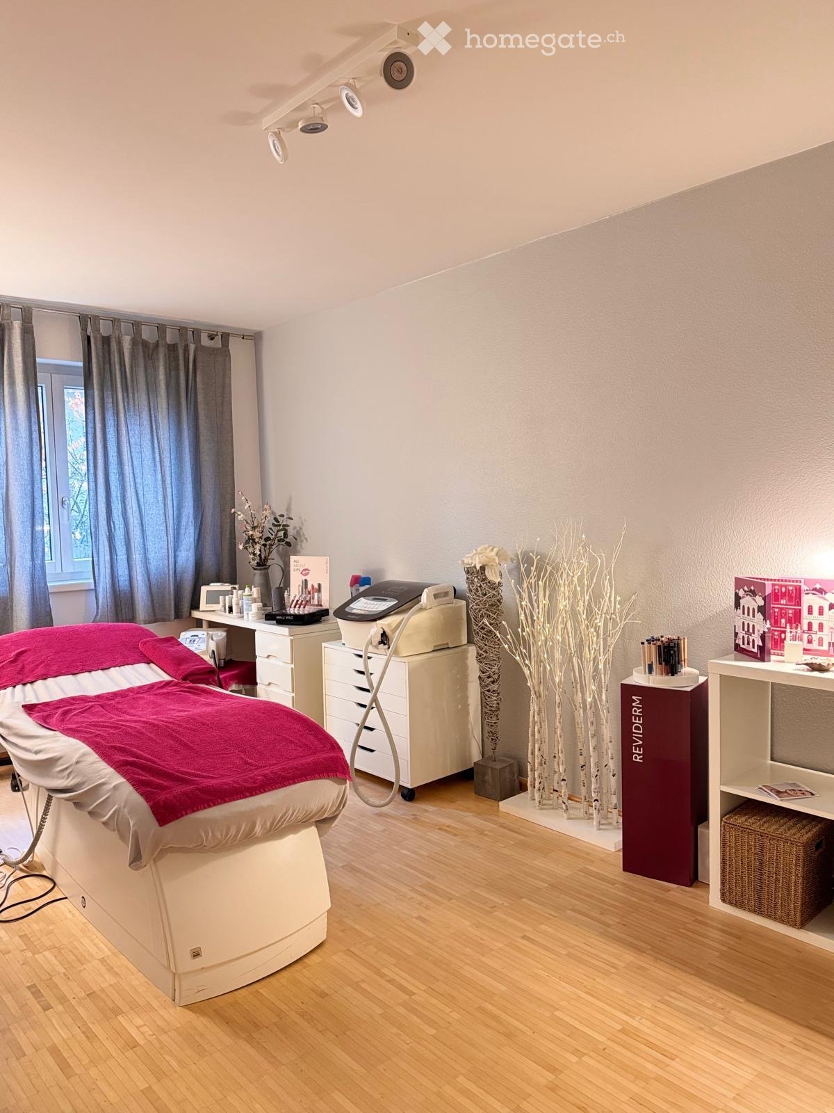 massage bed, white drawers, medical equipment, plants, cabinets, shelves