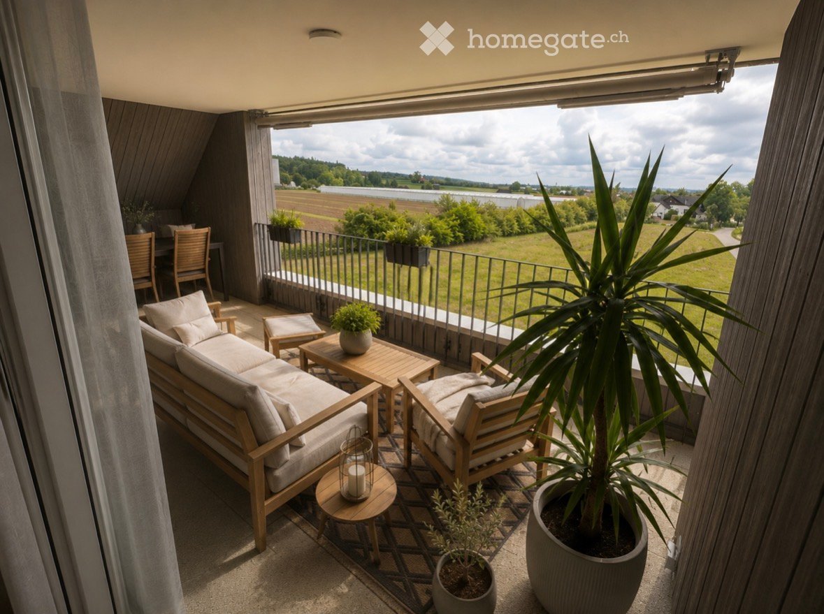 Balcony / Terrace. Balcony with wooden furniture, including a sofa, chairs, tables, and potted plants, overlooking a scenic countryside view.