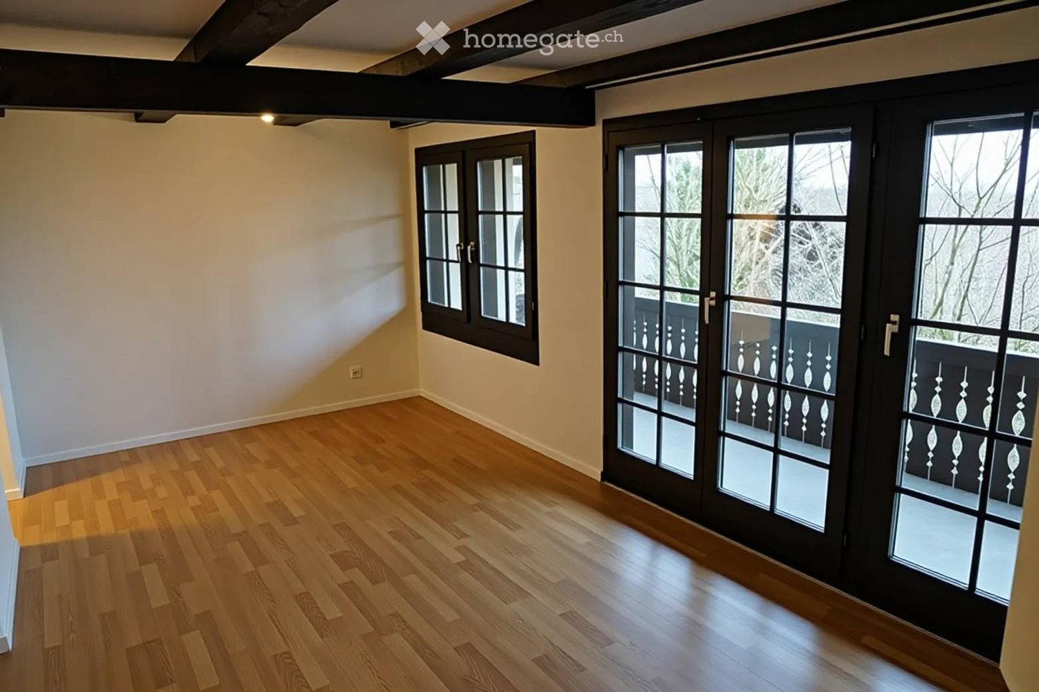 hardwood floor, white walls, two windows, sliding doors to balcony, empty room