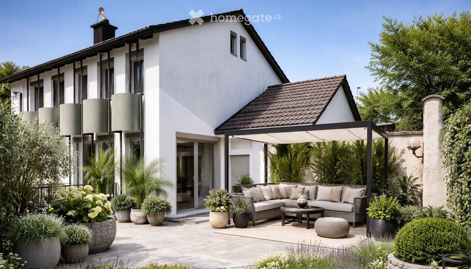 Garden / Outdoor Area. Modern house with a spacious outdoor patio featuring a sectional sofa, coffee table, and decorative plants.