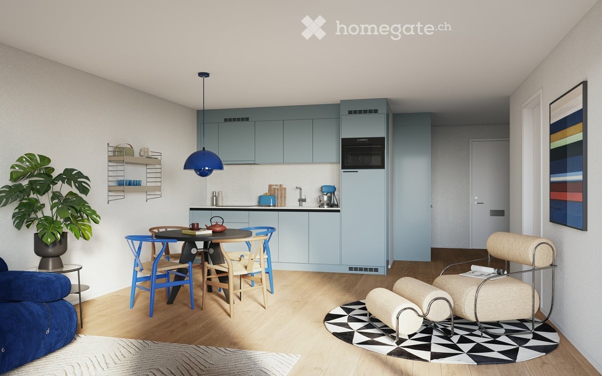 modern kitchen with dining area, blue cabinets, wooden floor, round table, blue chairs, blue sofa, potted plant, microwave, kettle, coffee machine, rug, lamp