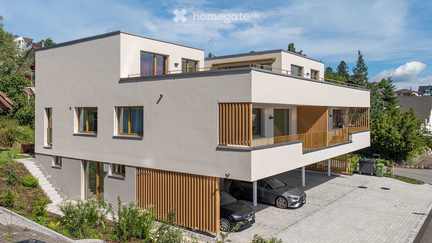 House. Modern two-story house with white facade, large windows, balconies, and a covered garage for two cars.