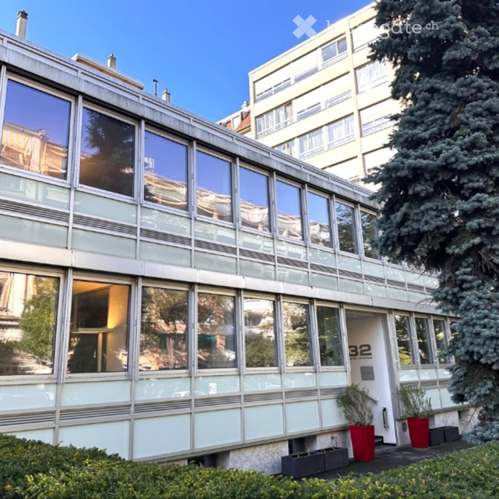 Modern style building, glass exteriors, multiple floors, potted plants