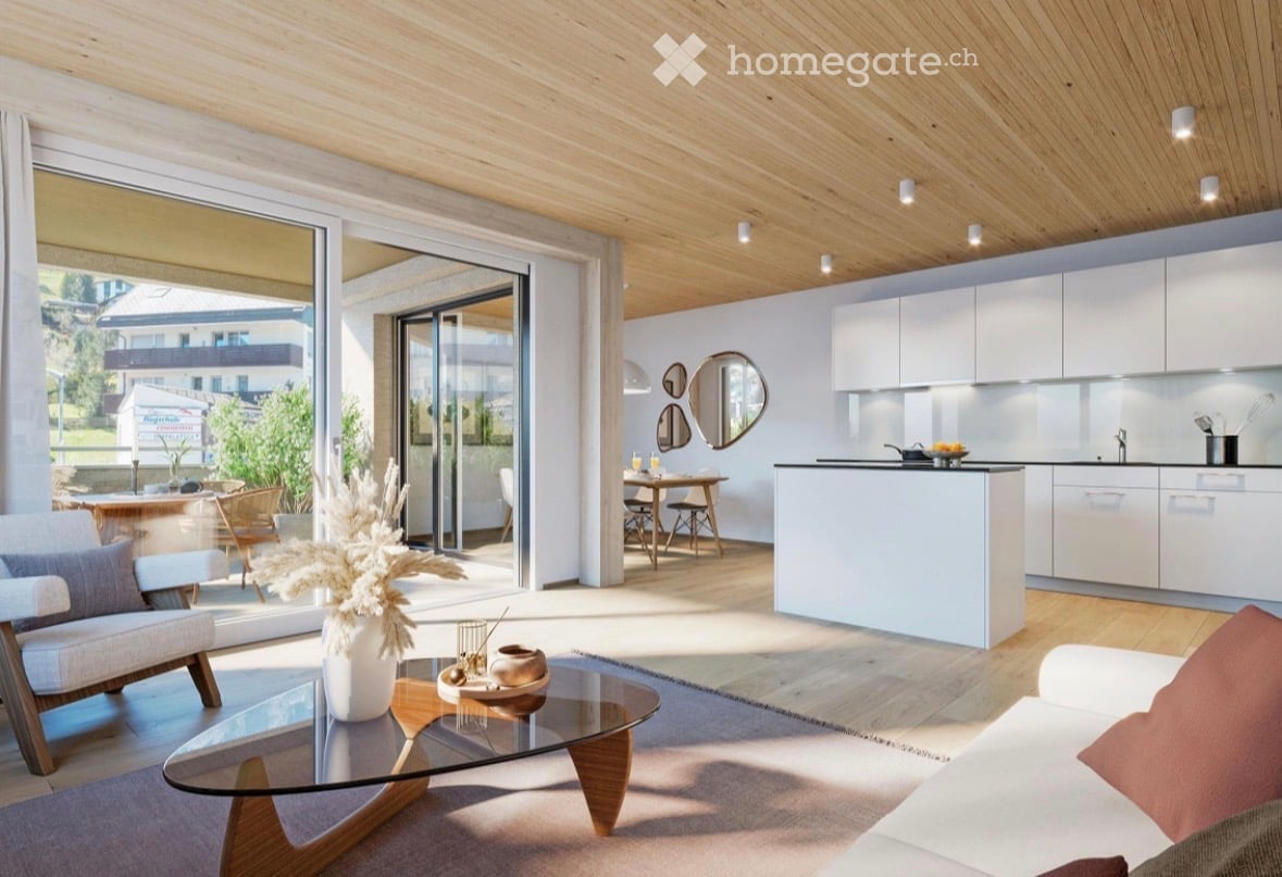 Modern open-plan living and dining area with a kitchen, featuring a glass coffee table, sofa, dining table, and kitchen cabinets.