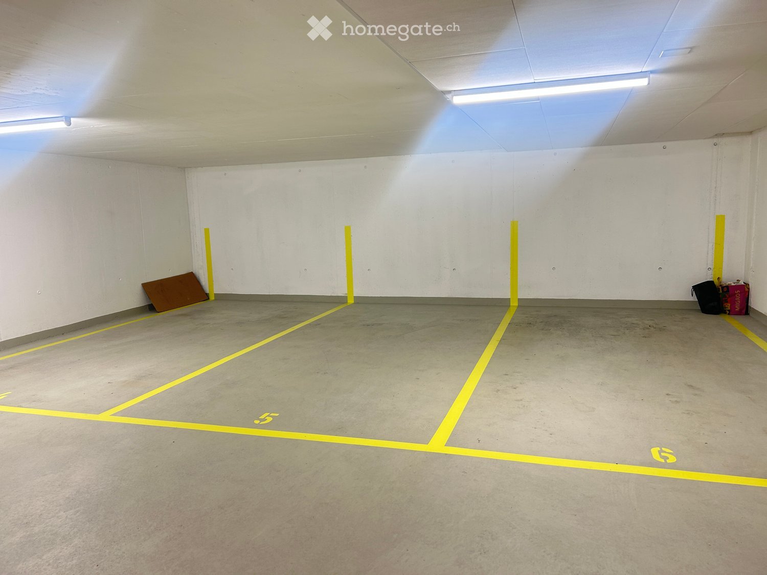 empty parking lot, white walls, yellow painted markings, number 5 and 6
