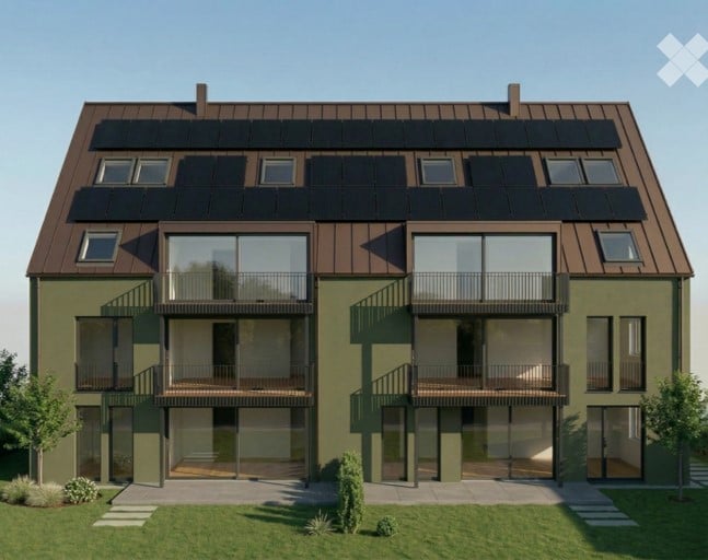 Modern two-story building with green facade, brown roof, multiple balconies, and solar panels on the roof.