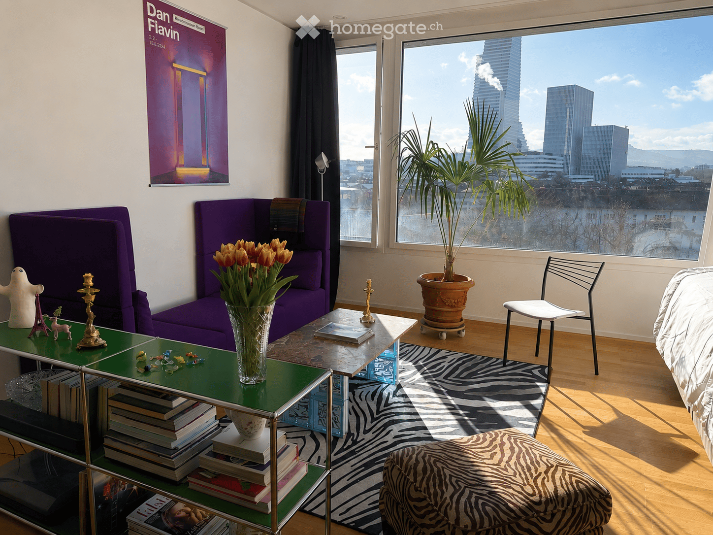 Furnished Room. Modern living room with purple sofa, zebra print rug, glass coffee table, potted plant, and city view through large windows.