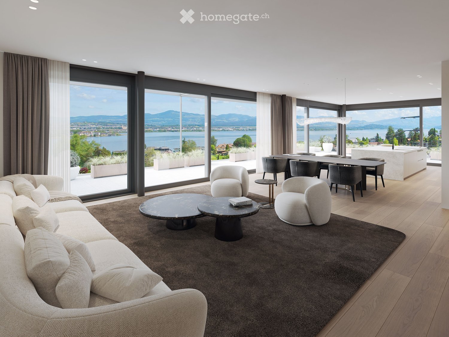 Modern living room with large windows offering a scenic view, featuring a sectional sofa, coffee tables, armchairs, and a dining area with a table and chairs.