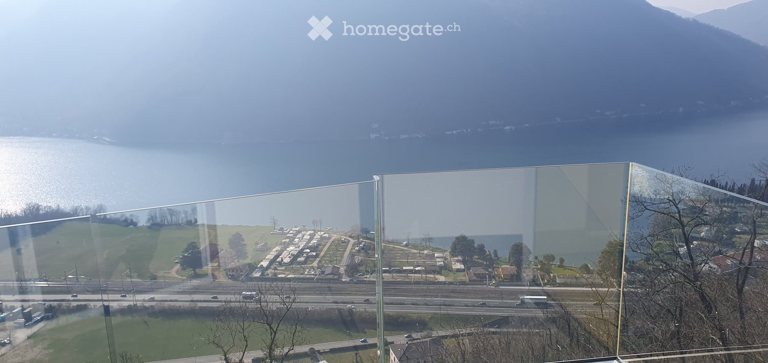 Balcony / Terrace. Balcony with expansive view of a lake, distant mountains, and surrounding landscape.