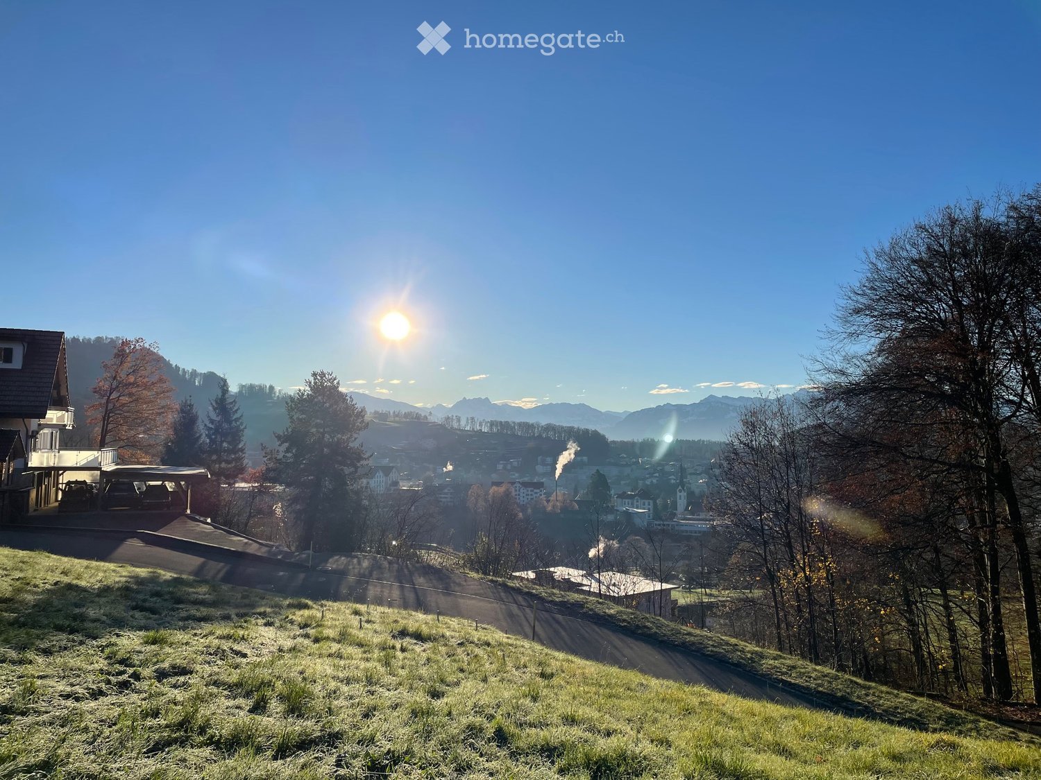 Wide view of hills, mountains, and a small town in the distance