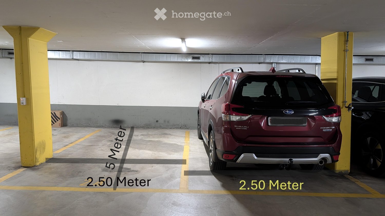 Underground parking area with a red Subaru Forester SUV parked in a designated spot, marked dimensions of 5 meters by 2.50 meters, and yellow support pillars.