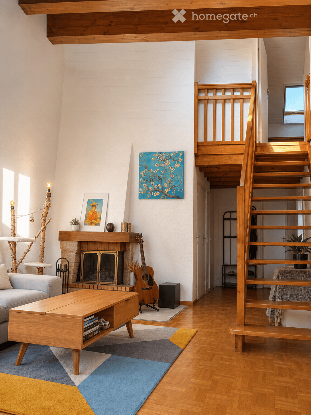 Living Room. Modern living room with wooden floors, a fireplace, a grey sofa, a wooden coffee table, a guitar, and a staircase leading to an upper level.