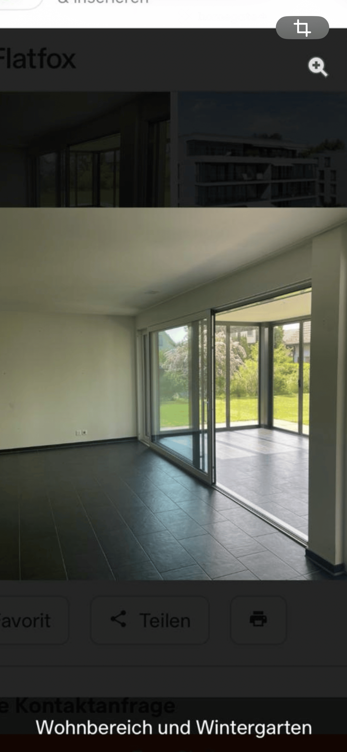 Empty room with large glass sliding doors leading to a patio, dark tiled floor, and white walls.