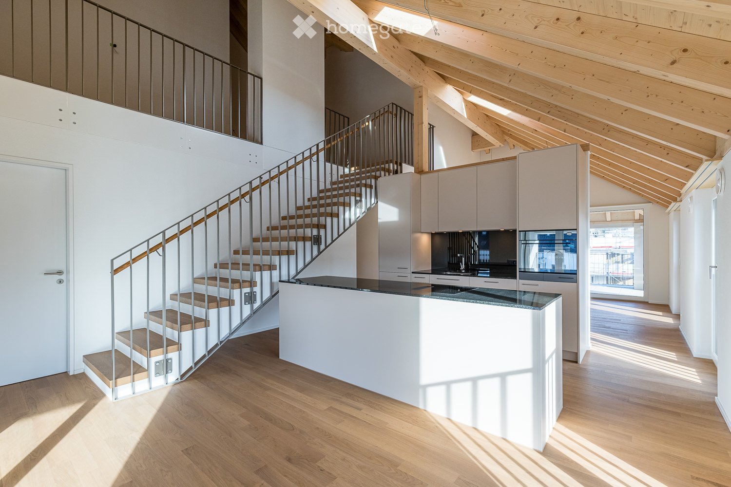 modern interior, wooden floor, white walls, wooden ceiling, kitchen island, staircase