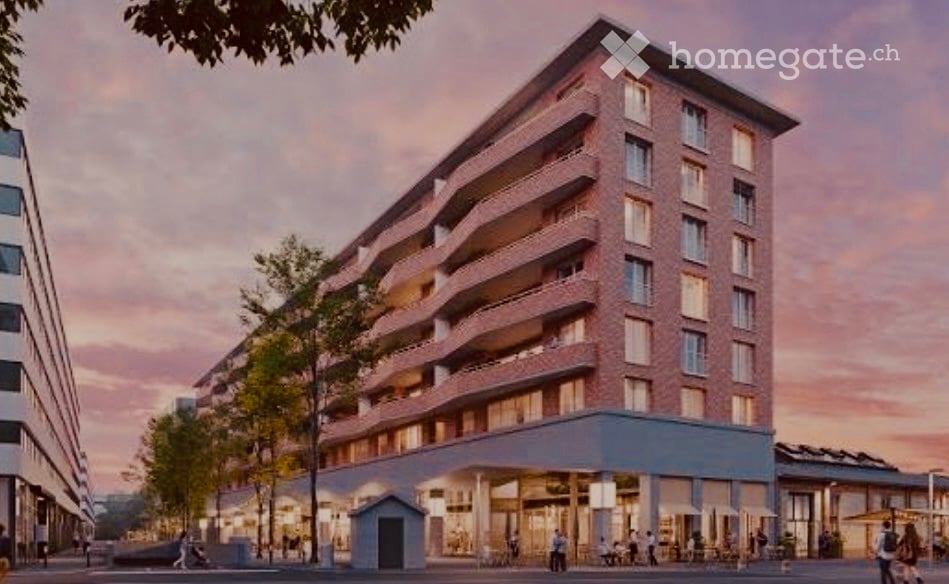 Modern multi-story apartment building with red brick facade, balconies, and a ground-floor commercial area with outdoor seating.