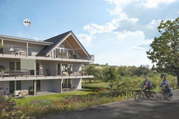 2 story house, white exterior, multiple balconies, garden, hot air balloon