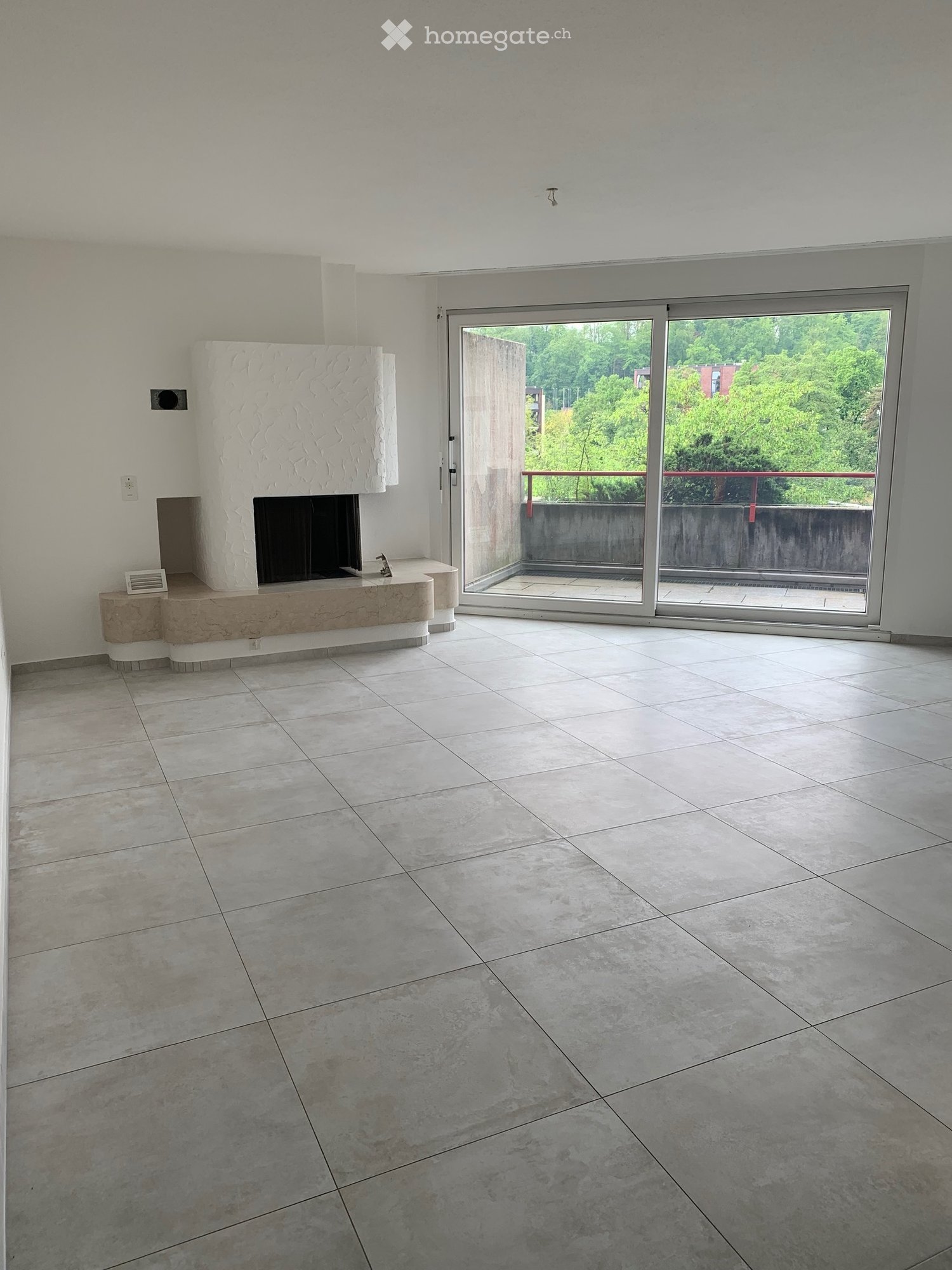 white tile floor, fireplace, sliding glass door, balcony