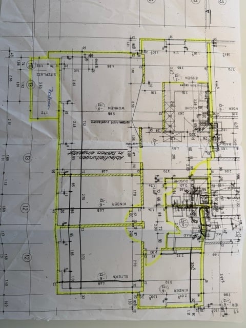 Floor plan of a residential building showing multiple rooms, including a living room, kitchen, bedrooms, and bathrooms, with labeled dimensions and room numbers.