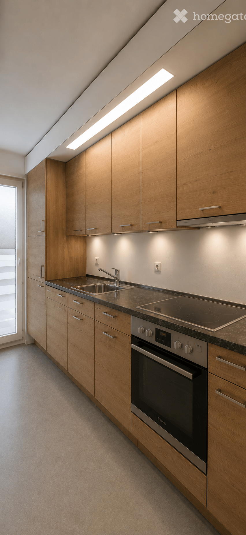 Modern kitchen with wooden cabinets, stainless steel appliances, and a sleek countertop.