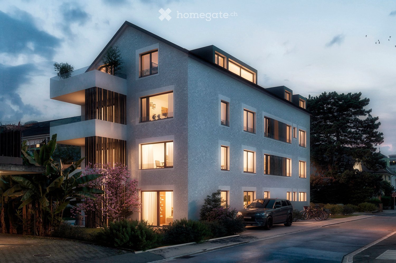 Modern two-story house with a sleek, contemporary design, featuring large windows, a balcony, and a well-maintained garden with trees and shrubs.