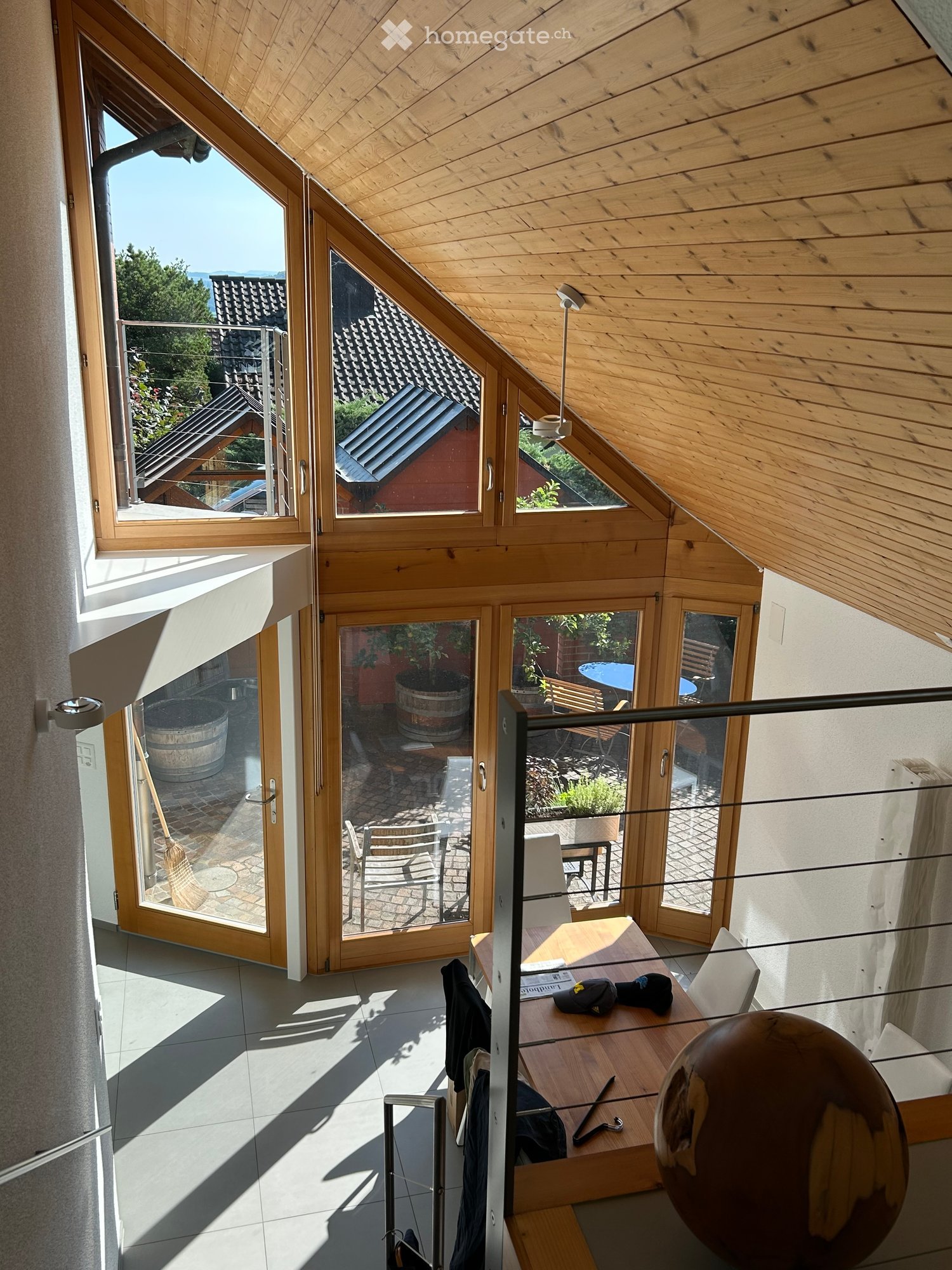 atrium style room, wooden ceiling, wooden floor, windows, terrace, garden, table, chairs