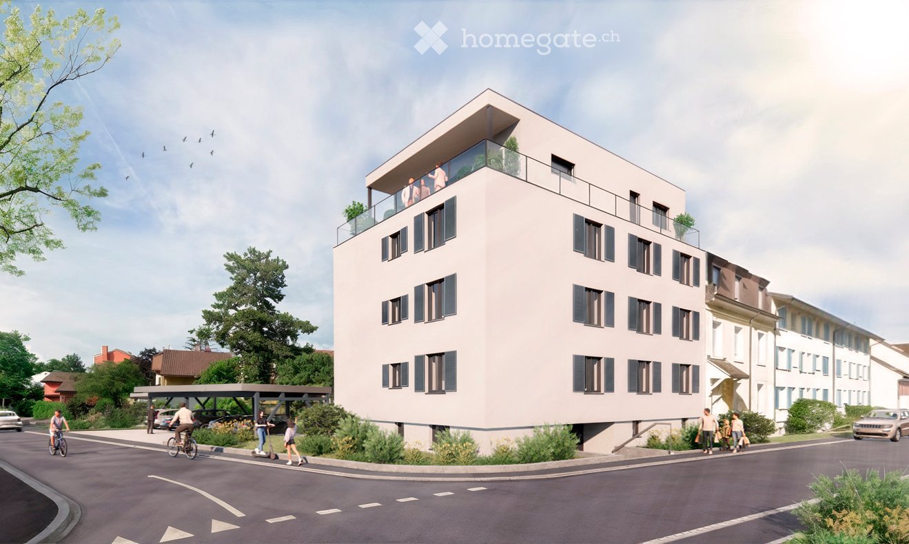 Modern multi-story residential building with balconies and a rooftop terrace, surrounded by greenery and a parking area.