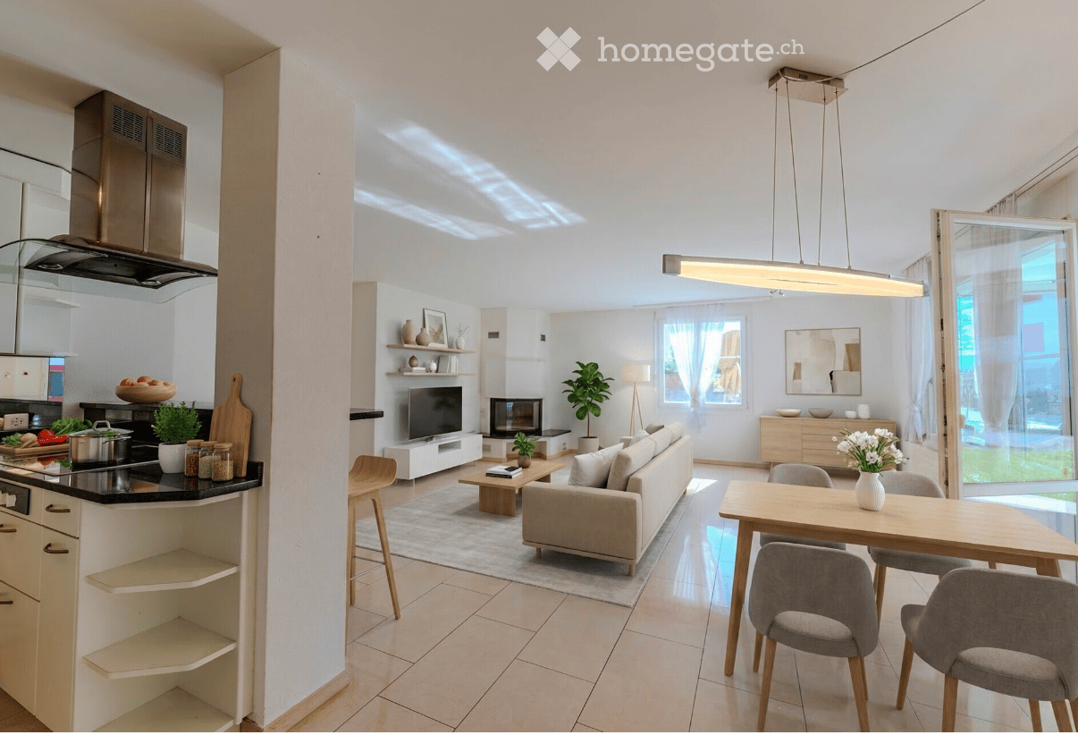 Modern open-plan living and dining area with a kitchen, featuring a sofa, coffee table, dining table with chairs, TV, fireplace, and kitchen appliances.