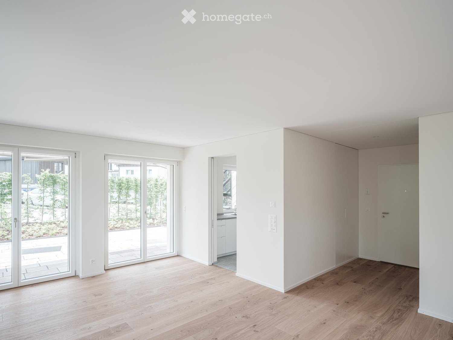 empty room, wooden floor, white walls, sliding glass doors, balcony