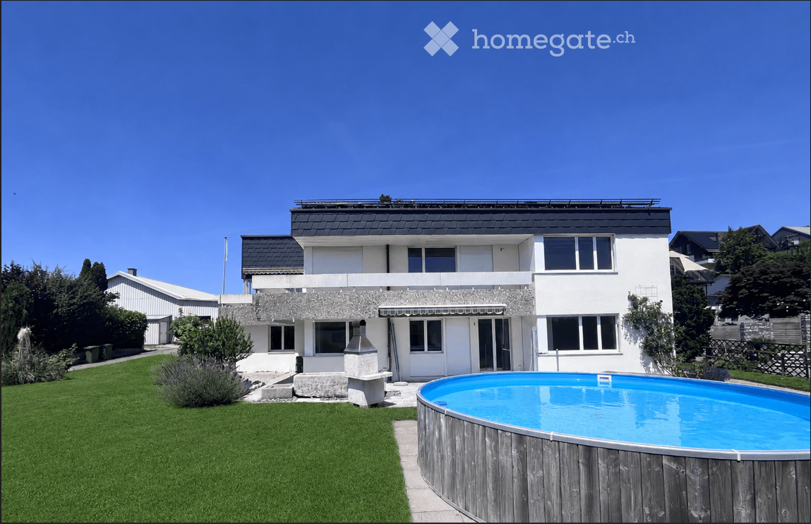 Modern two-story house with white exterior, large windows, and a swimming pool in the front yard.