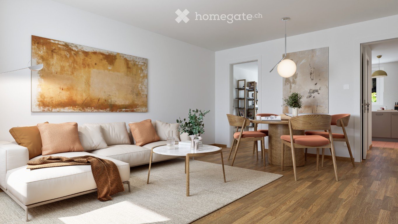Modern living room with white walls, wooden flooring, a white sectional sofa with orange cushions, a round coffee table, a small dining area with chairs and a table, pendant lighting, and wall art.