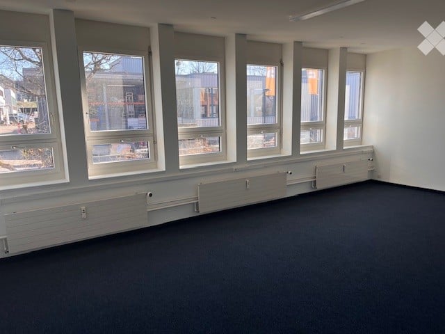 Completely empty room with bare walls and carpeted floor. No furniture or equipment.
