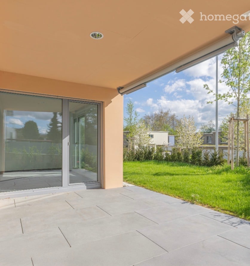 a glass sliding door on the balcony leading to the garden