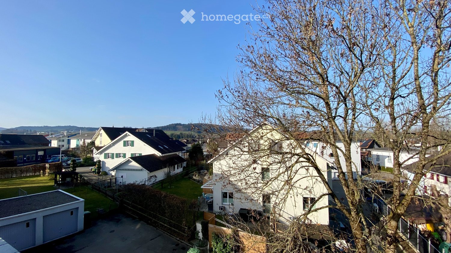 group of houses, detached houses, garages, mountains in the background