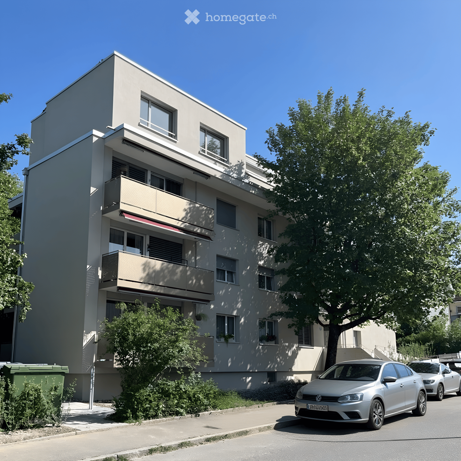 Modern multi-story residential building with balconies, large windows, and a parking area with cars.