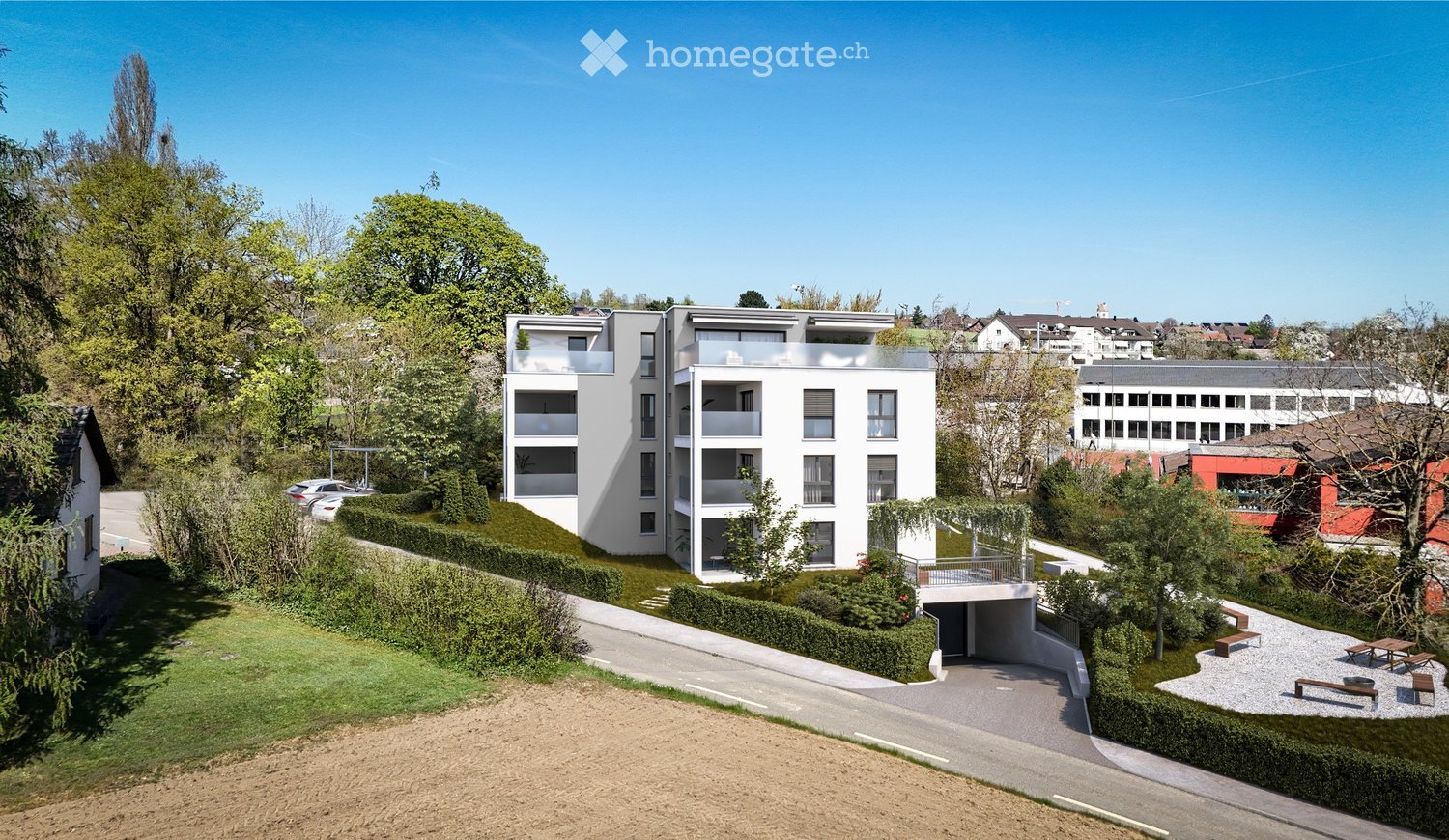 Modern multi-story residential building with balconies, surrounded by greenery and a parking area.