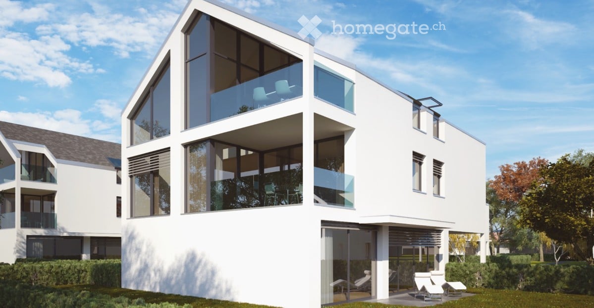 Modern two-story house with white exterior, large windows, balconies, and outdoor seating area.