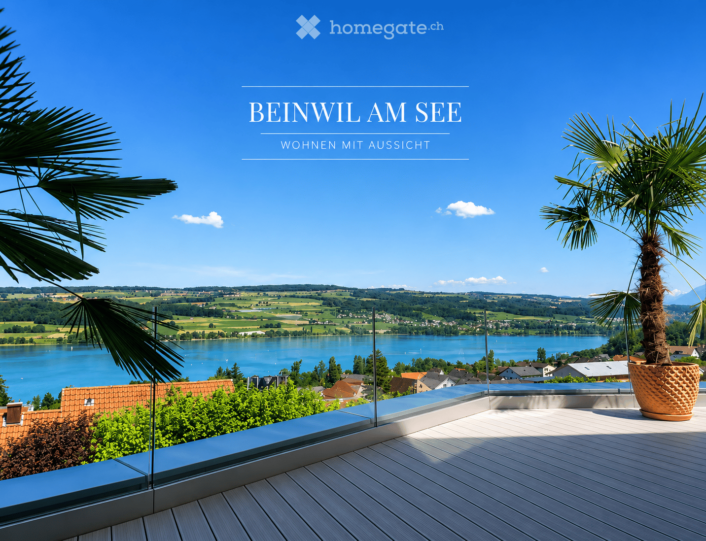 Balcony with wooden decking, glass railing, potted palm tree, scenic lake and countryside view.