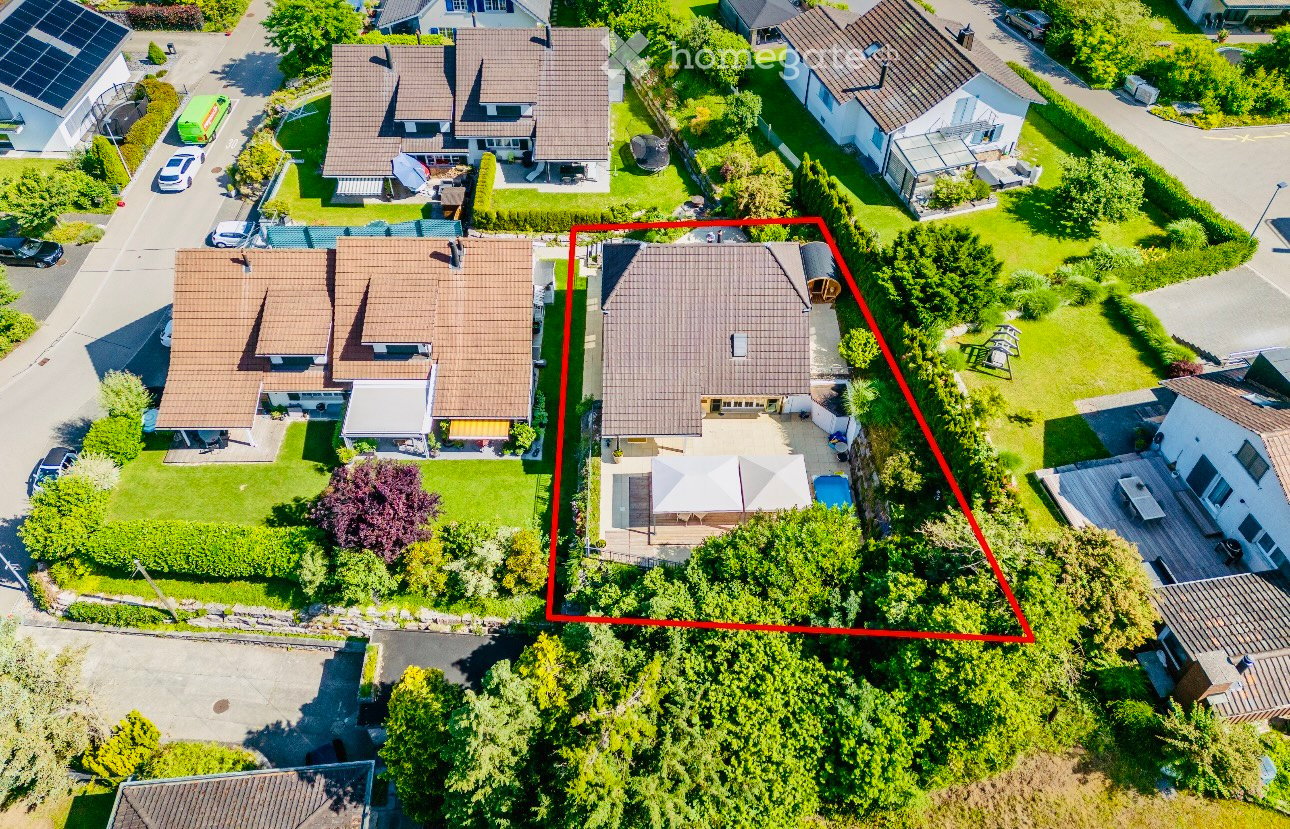 Large house with swimming pool, garage, and a view of the surrounding area