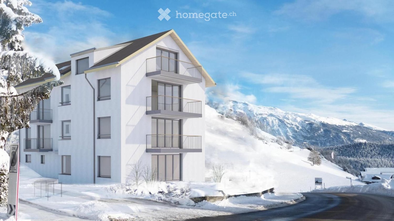 Modern white multi-story building with balconies, situated in a snowy mountain landscape with clear blue skies.