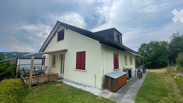 Single-family house with white exterior, red shutters, and a covered patio area with outdoor furniture.