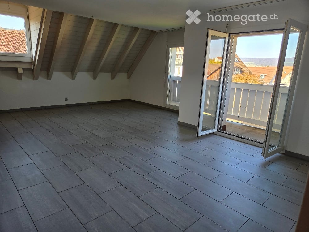 empty room with tiled flooring, two windows, double sliding glass doors leading to balcony